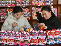 A craftsman sews tiger-head shoes in Lizhuang village, Zhangxibao town, Yongnian district, Handan city, North China's Hebei province, on Dec...