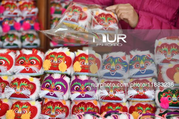 A craftsman packs tiger-head shoes in Lizhuang village, Zhangxibao town, Yongnian district, Handan city, North China's Hebei province, on De...