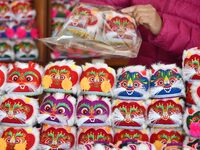 A craftsman packs tiger-head shoes in Lizhuang village, Zhangxibao town, Yongnian district, Handan city, North China's Hebei province, on De...