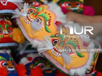 A craftsman shows tiger-head shoes in Lizhuang village, Zhangxibao town, Yongnian district, Handan, North China's Hebei province, on Decembe...