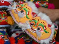 A craftsman shows tiger-head shoes in Lizhuang village, Zhangxibao town, Yongnian district, Handan, North China's Hebei province, on Decembe...