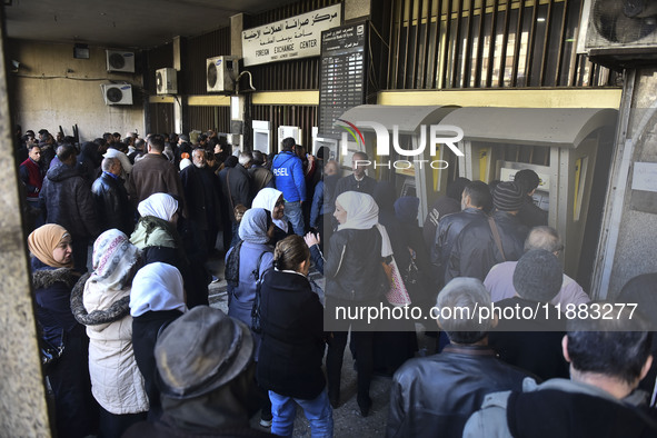 Crowds gather in front of all banks in Syria after a 9-day closure since the fall of the regime on December 19, 2024. 