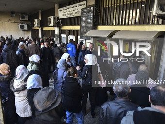 Crowds gather in front of all banks in Syria after a 9-day closure since the fall of the regime on December 19, 2024. (