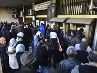 Crowds gather in front of all banks in Syria after a 9-day closure since the fall of the regime on December 19, 2024. (