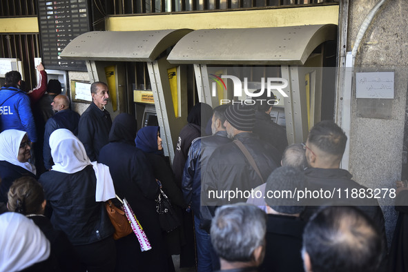 Crowds gather in front of all banks in Syria after a 9-day closure since the fall of the regime on December 19, 2024. 