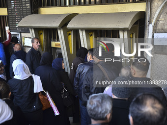 Crowds gather in front of all banks in Syria after a 9-day closure since the fall of the regime on December 19, 2024. (