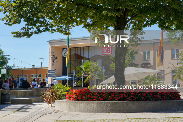 People stand in front of Traunstein Train Station in Traunstein, Bavaria, Germany, on September 16, 2023 