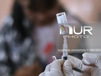 Medical personnel inject the HPV (Human Papillomavirus) vaccine into junior high school students in a classroom in Malang, East Java, Indone...