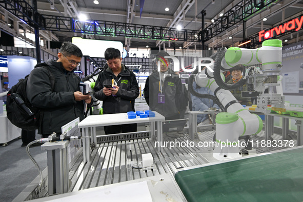 Visitors view smart devices at the World Intelligent Manufacturing Expo 2024 in Nanjing, China, on December 20, 2024. 