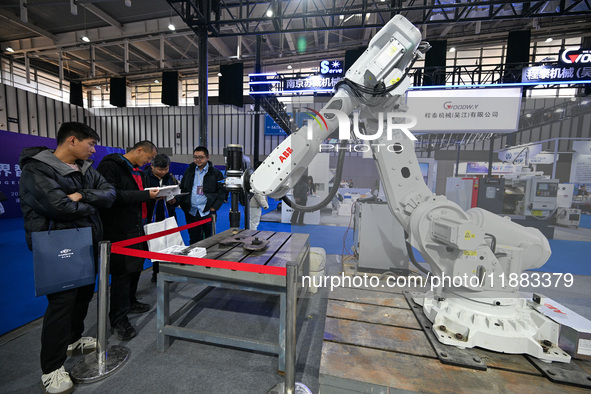 Visitors view smart devices at the World Intelligent Manufacturing Expo 2024 in Nanjing, China, on December 20, 2024. 