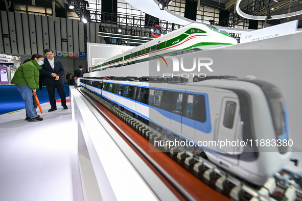 Visitors view a train model at the World Intelligent Manufacturing Expo 2024 in Nanjing, Jiangsu province, China, on December 20, 2024. 