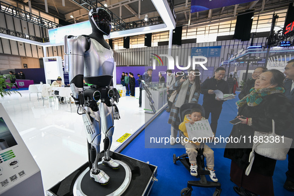 Visitors view a humanoid robot at the World Intelligent Manufacturing Expo 2024 in Nanjing, China, on December 20, 2024. 