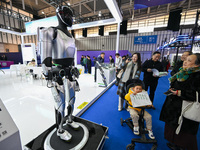 Visitors view a humanoid robot at the World Intelligent Manufacturing Expo 2024 in Nanjing, China, on December 20, 2024. (