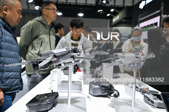 Visitors view DJI drones at the World Intelligent Manufacturing Expo 2024 in Nanjing, China, on December 20, 2024. 