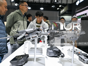 Visitors view DJI drones at the World Intelligent Manufacturing Expo 2024 in Nanjing, China, on December 20, 2024. (