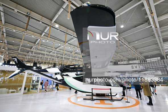 Visitors view electric vertical take-off and landing aircraft at the World Intelligent Manufacturing Expo 2024 in Nanjing, China, on Decembe...