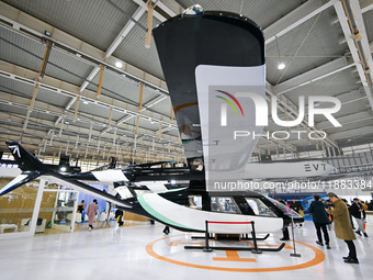 Visitors view electric vertical take-off and landing aircraft at the World Intelligent Manufacturing Expo 2024 in Nanjing, China, on Decembe...