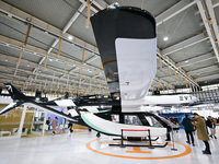 Visitors view electric vertical take-off and landing aircraft at the World Intelligent Manufacturing Expo 2024 in Nanjing, China, on Decembe...