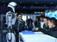 Visitors view a humanoid robot at the World Intelligent Manufacturing Expo 2024 in Nanjing, China, on December 20, 2024. (