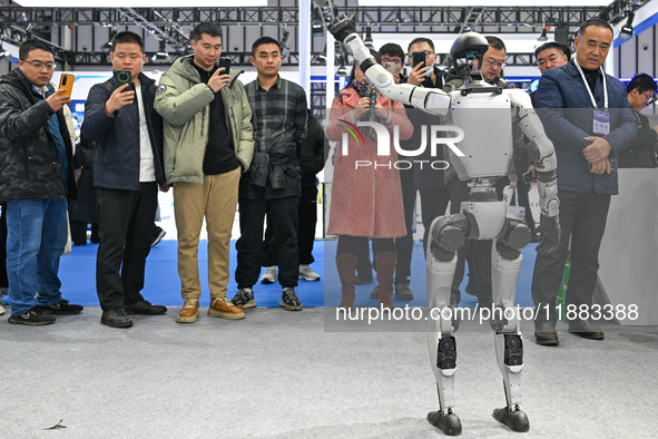 Visitors view a humanoid robot at the World Intelligent Manufacturing Expo 2024 in Nanjing, China, on December 20, 2024. 