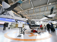 Visitors view electric vertical take-off and landing aircraft at the World Intelligent Manufacturing Expo 2024 in Nanjing, China, on Decembe...