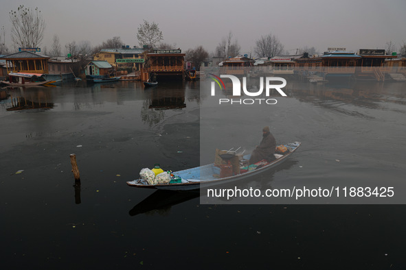 A vendor serves breakfast to tourists in a shikara on a cold winter morning at Dal Lake in Srinagar, Jammu and Kashmir, India, on December 2...