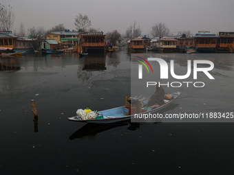 A vendor serves breakfast to tourists in a shikara on a cold winter morning at Dal Lake in Srinagar, Jammu and Kashmir, India, on December 2...