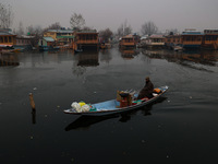 A vendor serves breakfast to tourists in a shikara on a cold winter morning at Dal Lake in Srinagar, Jammu and Kashmir, India, on December 2...