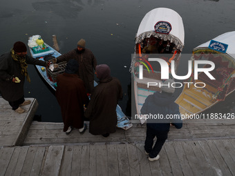 A vendor serves breakfast to tourists in a shikara on a cold winter morning at Dal Lake in Srinagar, Jammu and Kashmir, India, on December 2...