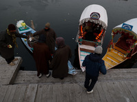 A vendor serves breakfast to tourists in a shikara on a cold winter morning at Dal Lake in Srinagar, Jammu and Kashmir, India, on December 2...