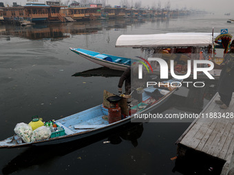 A vendor serves breakfast to tourists in a shikara on a cold winter morning at Dal Lake in Srinagar, Jammu and Kashmir, India, on December 2...