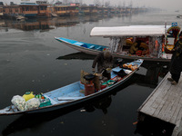 A vendor serves breakfast to tourists in a shikara on a cold winter morning at Dal Lake in Srinagar, Jammu and Kashmir, India, on December 2...