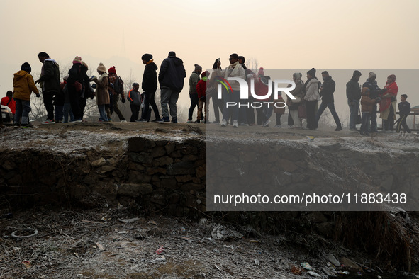 Tourists take a shikara ride on a cold winter morning at Dal Lake in Srinagar, Jammu and Kashmir, India, on December 20, 2024. Srinagar expe...