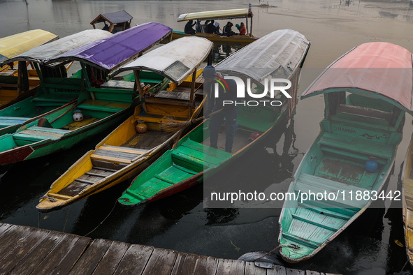 Tourists take a shikara ride on a cold winter morning at Dal Lake in Srinagar, Jammu and Kashmir, India, on December 20, 2024. Srinagar expe...