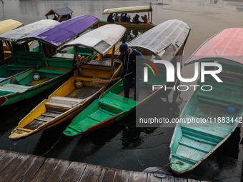 Tourists take a shikara ride on a cold winter morning at Dal Lake in Srinagar, Jammu and Kashmir, India, on December 20, 2024. Srinagar expe...