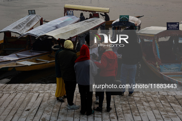 Tourists take a shikara ride on a cold winter morning at Dal Lake in Srinagar, Jammu and Kashmir, India, on December 20, 2024. Srinagar expe...