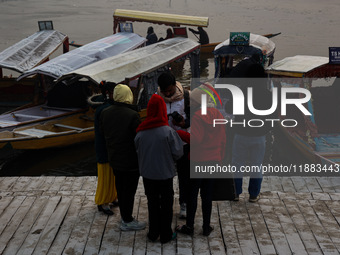 Tourists take a shikara ride on a cold winter morning at Dal Lake in Srinagar, Jammu and Kashmir, India, on December 20, 2024. Srinagar expe...