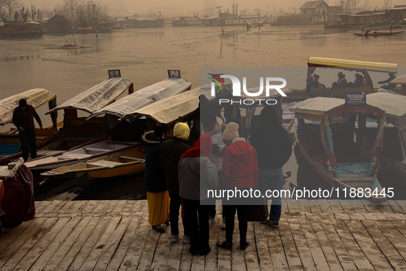 Tourists take a shikara ride on a cold winter morning at Dal Lake in Srinagar, Jammu and Kashmir, India, on December 20, 2024. Srinagar expe...