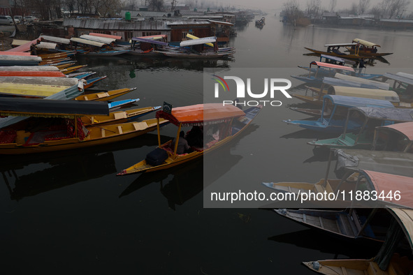 Tourists take a shikara ride on a cold winter morning at Dal Lake in Srinagar, Jammu and Kashmir, India, on December 20, 2024. Srinagar expe...