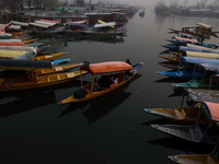 Tourists take a shikara ride on a cold winter morning at Dal Lake in Srinagar, Jammu and Kashmir, India, on December 20, 2024. Srinagar expe...