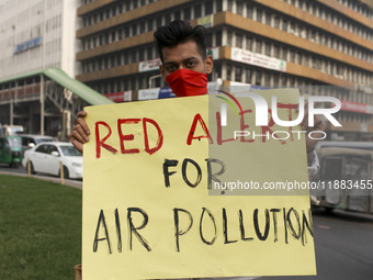 Bangladesh Gach Raksha Andolan, an organization that works on environmental issues, holds a red alert program to demand the control of air p...