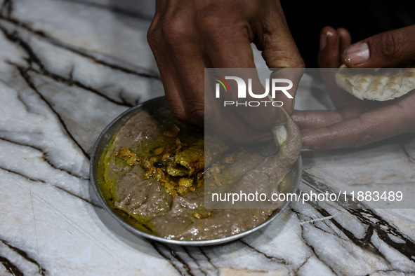 Harissa is prepared and served to customers on a cold winter day in Srinagar, Jammu and Kashmir, India, on December 20, 2024. This tradition...