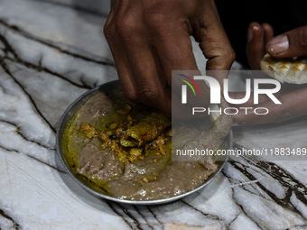 Harissa is prepared and served to customers on a cold winter day in Srinagar, Jammu and Kashmir, India, on December 20, 2024. This tradition...