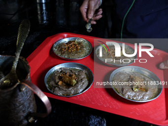 Harissa is prepared and served to customers on a cold winter day in Srinagar, Jammu and Kashmir, India, on December 20, 2024. This tradition...