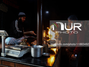 Harissa is prepared and served to customers on a cold winter day in Srinagar, Jammu and Kashmir, India, on December 20, 2024. This tradition...