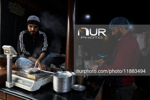 Harissa is prepared and served to customers on a cold winter day in Srinagar, Jammu and Kashmir, India, on December 20, 2024. This tradition...