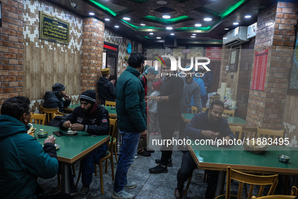 Harissa is prepared and served to customers on a cold winter day in Srinagar, Jammu and Kashmir, India, on December 20, 2024. This tradition...