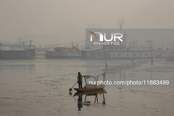 A boatman rows his boat on a cold winter day in Srinagar, Jammu and Kashmir, India, on December 20, 2024. 