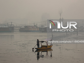 A boatman rows his boat on a cold winter day in Srinagar, Jammu and Kashmir, India, on December 20, 2024. (