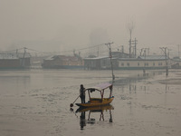 A boatman rows his boat on a cold winter day in Srinagar, Jammu and Kashmir, India, on December 20, 2024. (